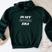 a green hoodie that says in my father era