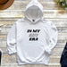 a white hoodie with the words in my adru era printed on it