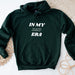 a green hoodie with the words in my dad era printed on it